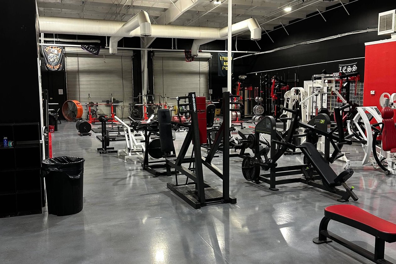 Modern gym with black and red equipment, exposed ductwork